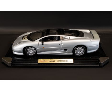 A Maisto 1:12th Scale Diecast Model Jaguar Model: XJ220 (1992) Displayed On Plastic Plinth.