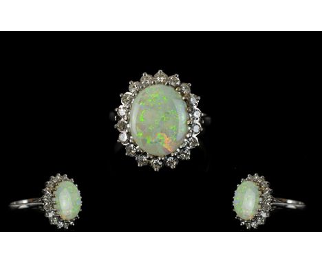 Ladies 18ct White Gold Opal & Diamond Set Cluster Ring appealing flower head design marked 18ct.  The central cabuchon cut op