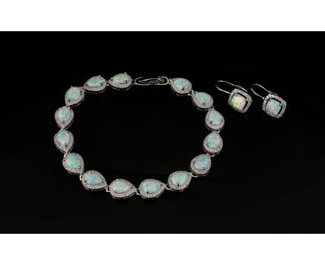 Opal and Zirconia Tennis Bracelet and Pair of Drop Earrings, the bracelet comprising fifteen pear cut, high quality Opals, se