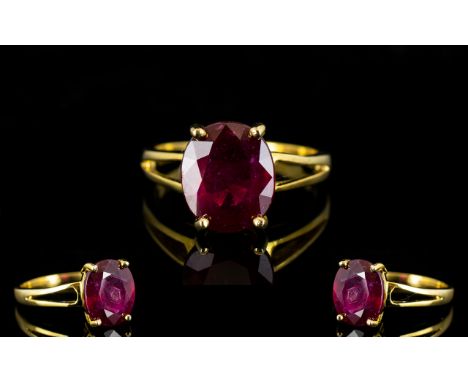 Ruby Oval Cut Solitaire Ring, a 6.5ct oval cut ruby of excellent colour, in a simple, split shouldered setting of 14ct gold v