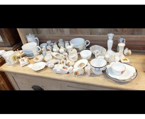 An assortment of souvenir china including two First Word War tanks - on three shelves