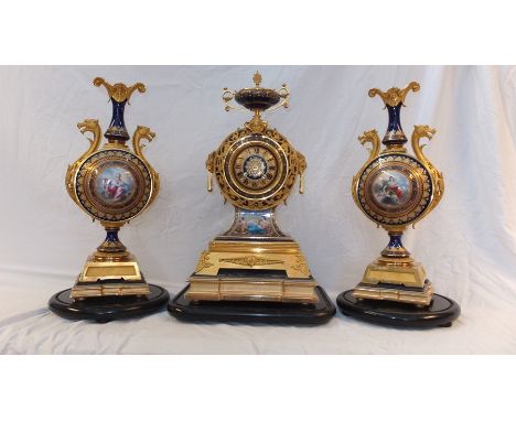 A Victorian, exhibition quality, three piece clock set with ormolu blue enamel design and hand painted panels - the striking 