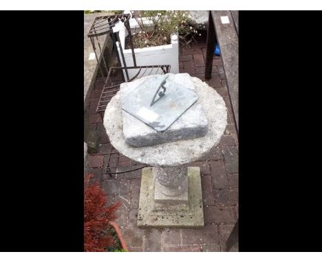 A sundial on plinth, together with a wrought iron plant stand 
