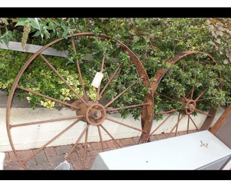 A pair of vintage wrought iron cartwheels 