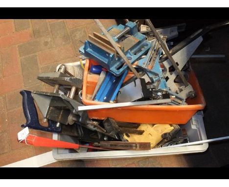 A box of assorted tools including saws and planes
