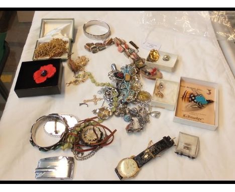 A bag of assorted costume jewellery including Scottish kilt plume and Timex wrist watch