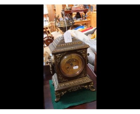 A decorative antique striking brass cased mantel clock - 40cm high 