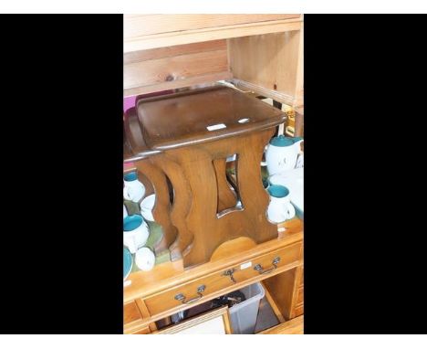 A nest of three Ercol elm occasional tables together with an Ercol plate rack