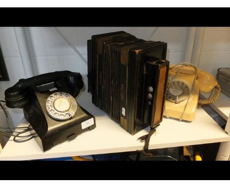 A vintage black Bakelite telephone, a retro telephone together with an accordion