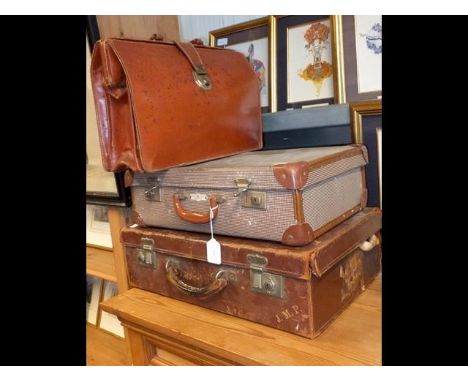 A vintage leather suitcase, another suitcase together with a briefcase 