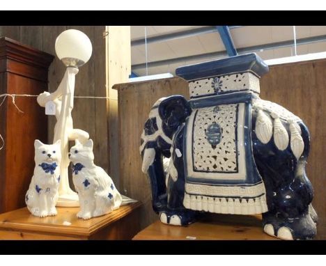 An Art Deco style female figure table lamp, ceramic elephant seat together with a pair of blue decorated cats