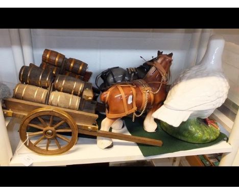 Two ceramic cart horses with drays together with a ceramic bird