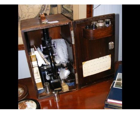 A Spencer Buffalo microscope with fitted case and selection of interchangeable lenses 