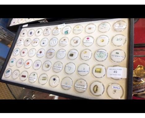 A tray containing various collectable gems, including topaz, ruby, aquamarine and other 