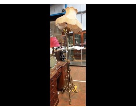 An antique adjustable brass standard lamp 