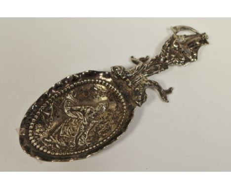 A late Victorian silver caddy spoon, surmounted with a galleon full sail with stylised dolphin mounted table rest, the bowl e