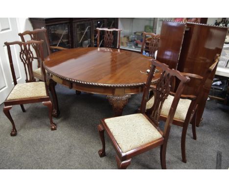 A mahogany oval windout dining table, gadrooned border, deep frieze, cabriole legs, acanthus carved knees, ball and claw feet