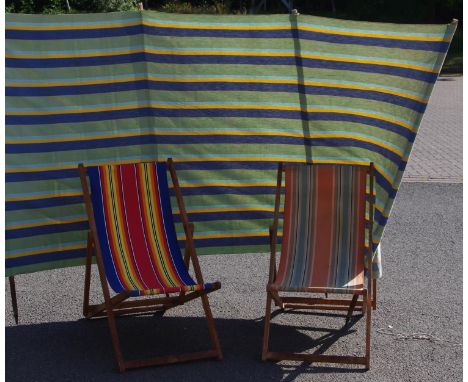 Two vintage deck chairs and a wind break