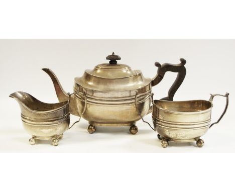 A silver three piece tea set, teapot, banded collar, ball feet, ebony finial and handle Thomas Bradbury &amp; Sons Ltd, Sheff