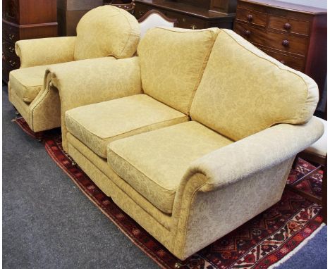 A modern two seat sofa and conforming armchair.