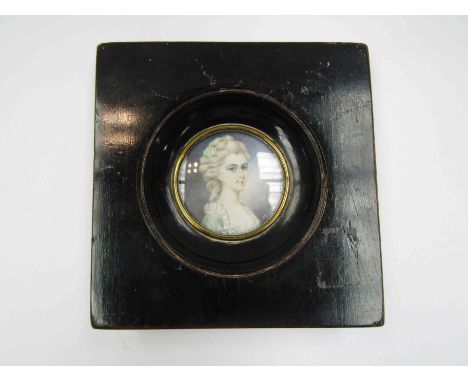 A Victorian miniature oil portrait with ebonised frame, 4.3cm diameter