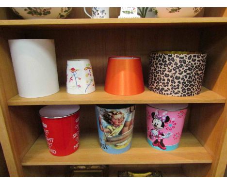 Four various lamp shades including faux leopard skin effect and three children's waste paper bins