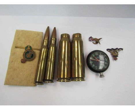 Four brass shell casings, a smith's military watch with magnetic back and assorted badges including Women's Land Army