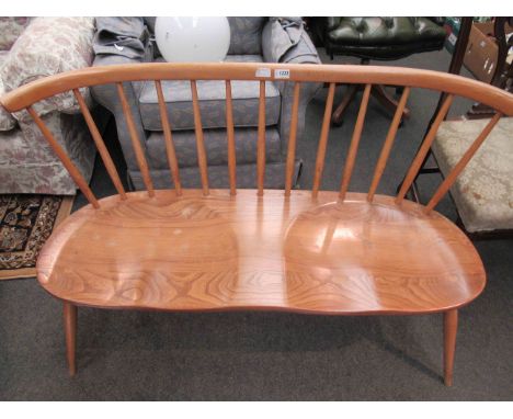 An Ercol two seater love seat with elm seat and stick back, 113cm long x 75cm high x 43cm deep 