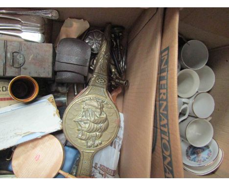 Two boxes of assorted wares including brass fire bellows, oil lamp, nutcrackers, cutlery and  assorted Royal commemorative mu