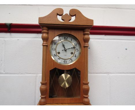 A Tempus 31-day wall clock with key and pendulum 