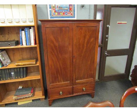 A George III mahogany gentleman's linen press with twin panelled doors over two short drawers to shaped bracket feet, stamped