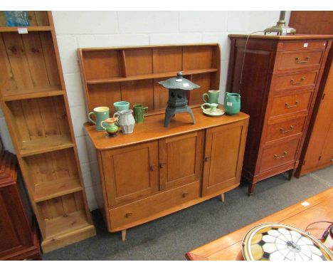 An Ercol elm dresser with raised plate rack back over three doors and single drawer base, 130cm high x 115cm wide x 46cm deep