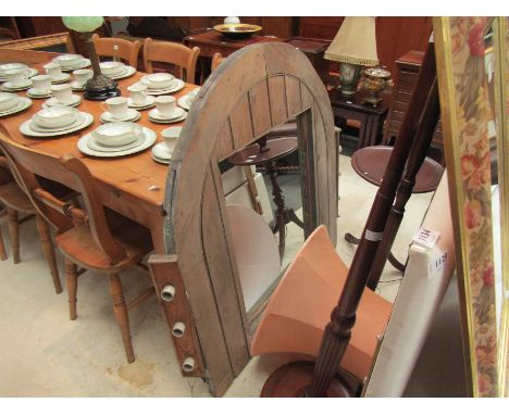 A pitch pine mirror of large proportions, arch top flanked by light fittings, 115cm high