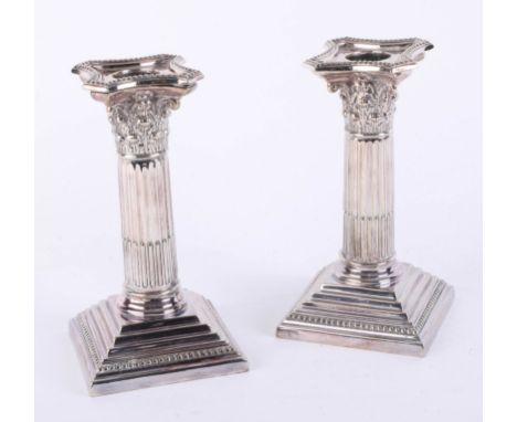A pair of Walker and Hall Corinthian column candlesticks, each with removal sconces with step bases, height 15.2 cm, width 9.