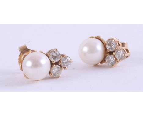 A pair of pearl and diamond set earrings, set in unmarked yellow gold, in original box (purchased in Oman).