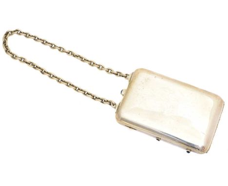 An early 20th century silver minaudiere, of rectangular form with chain handle and blue glass cabochon buttons, opening to re