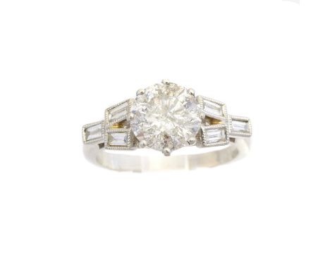 A platinum diamond single stone ring, the brilliant cut diamond with baguette cut diamond trefoil sides, estimated total diam