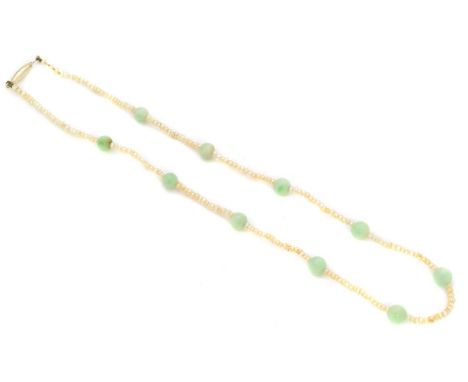 A seed pearl and jade necklace, the single strand seed pearl necklace with polished jade bead spacers, clasp stamped 9c, leng