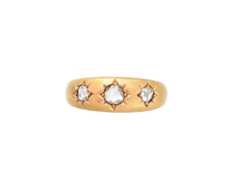 A late Victorian 18ct gold diamond three stone ring, the rose cut diamond trio star set to the tapered band, hallmarks for Bi