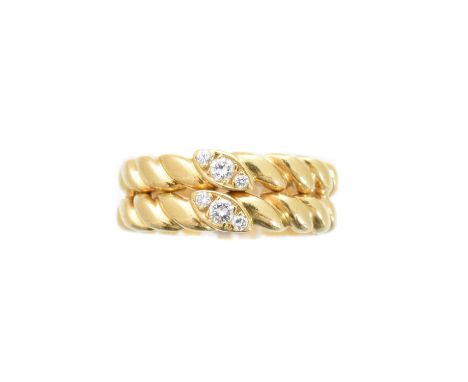 An 18ct gold diamond band ring by Van Cleef & Arpels, the grooved double band with brilliant cut diamond accents, estimated t