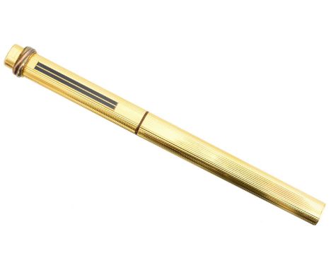 A Cartier gold plated Trilogy pen, the grooved ballpoint pen with blue enamel accent and trilogy terminal, signed and numbere