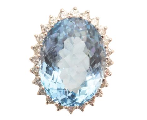 A blue topaz and diamond cluster ring, the oval shape blue topaz weighing approx. 26cts within a brilliant cut diamond surrou