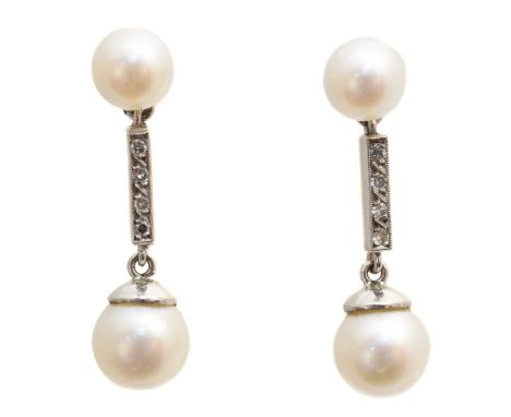A pair of cultured pearl and diamond earrings, each designed as a cultured pearl drop, with single cut diamond bar spacer and