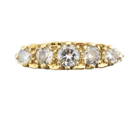 An 18ct gold diamond five stone ring, designed as a brilliant cut diamond line within a scrolling setting, estimated total di