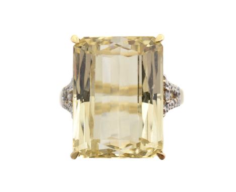 A 9ct gold spodumene and diamond dress ring, the rectangular yellow spodumene weighing approx. 15.5cts within a four claw set