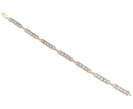 A 9ct gold tanzanite bracelet, designed as an oval shape tanzanite line with openwork link spacers, hallmarks for Birmingham,