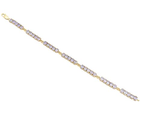 A 9ct gold tanzanite bracelet, designed as an oval shape tanzanite line with openwork link spacers, hallmarks for Birmingham,