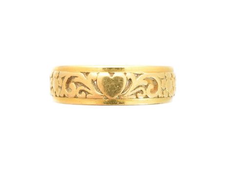 A band ring, the floral openwork band with polished sides, stamped 22ct, ring size R, gross weight 7g.Condition report: Overa