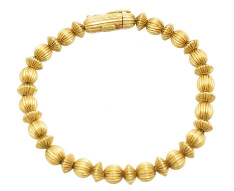 A bracelet by Ilias Lalaounis, designed as a series of grooved beads with a cylindrical push piece clasp, maker's marks for I