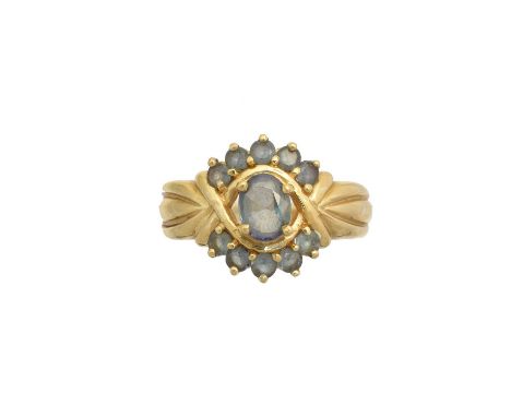 An 18ct gold synthetic alexandrite cluster ring, the oval shape synthetic alexandrite within a circular shape synthetic alexa